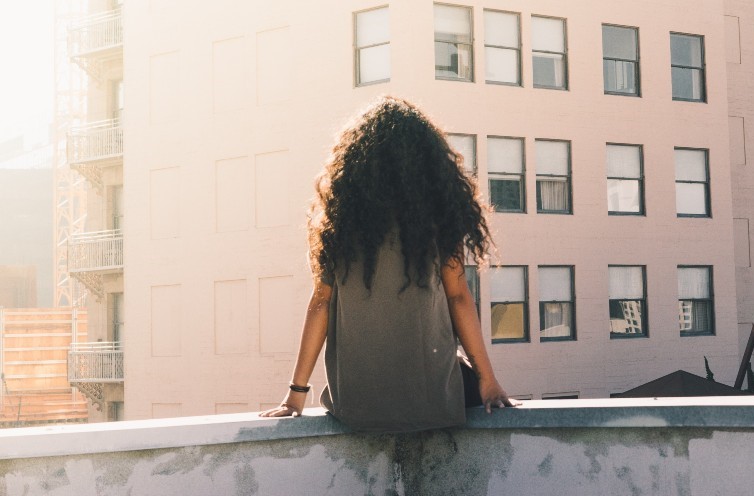 Black girl sitting on ledge